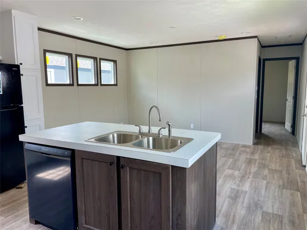 a kitchen with stainless steel appliances granite countertop a sink and a refrigerator