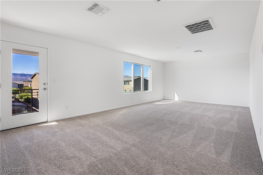 5670 Spring Trellis Street Las Vegas, NV 89113 - Photo 11 of 23 Empty room with light carpet