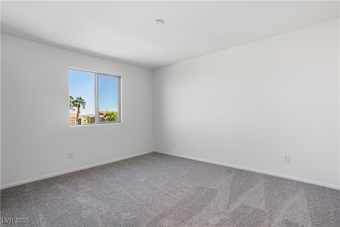 5670 Spring Trellis Street Las Vegas, NV 89113 - Photo 13 of 23 Empty room featuring carpet flooring and baseboards