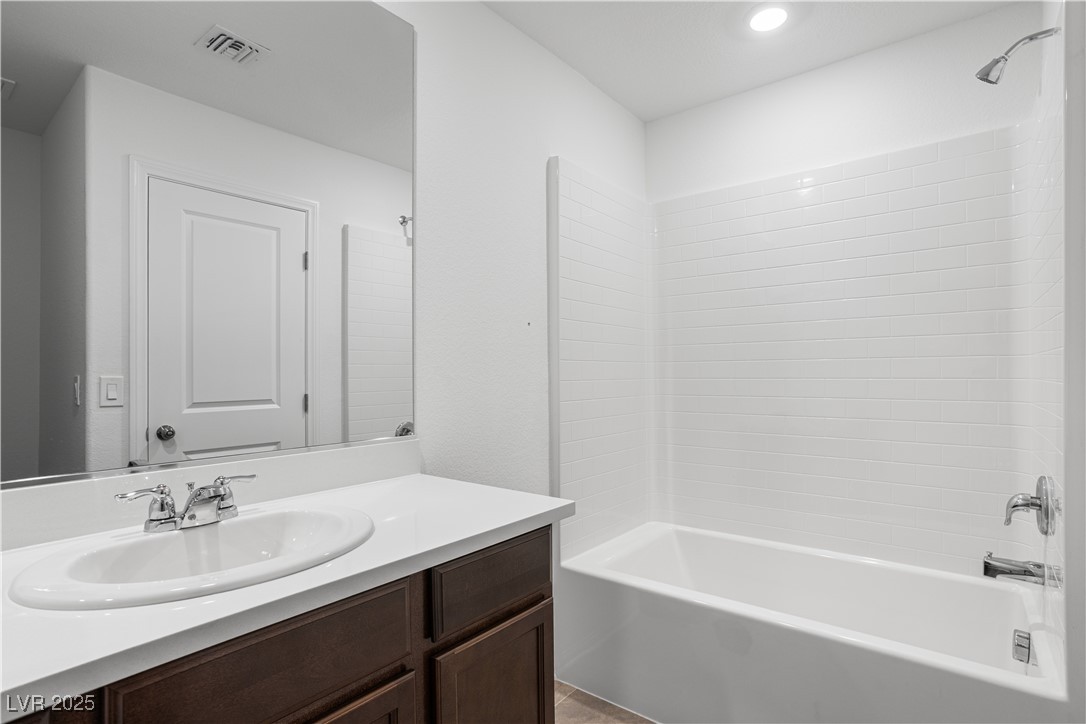 5670 Spring Trellis Street Las Vegas, NV 89113 - Photo 14 of 23 Bathroom with tub / shower combination and vanity