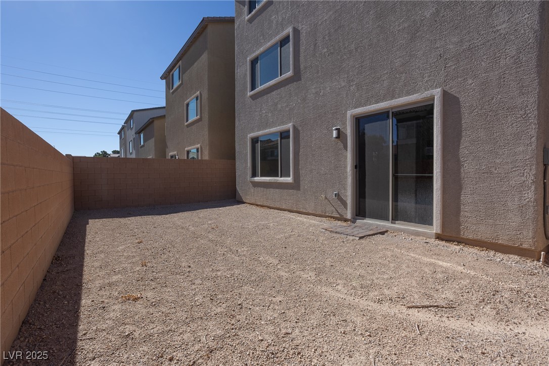 5670 Spring Trellis Street Las Vegas, NV 89113 - Photo 15 of 23 Back of property featuring stucco siding and a fenced backyard