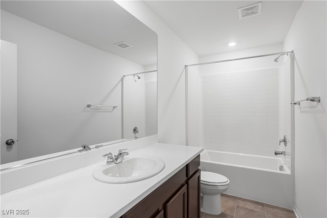5670 Spring Trellis Street Las Vegas, NV 89113 - Photo 7 of 23 Full bathroom featuring vanity, shower / tub combination, and light tile patterned floors