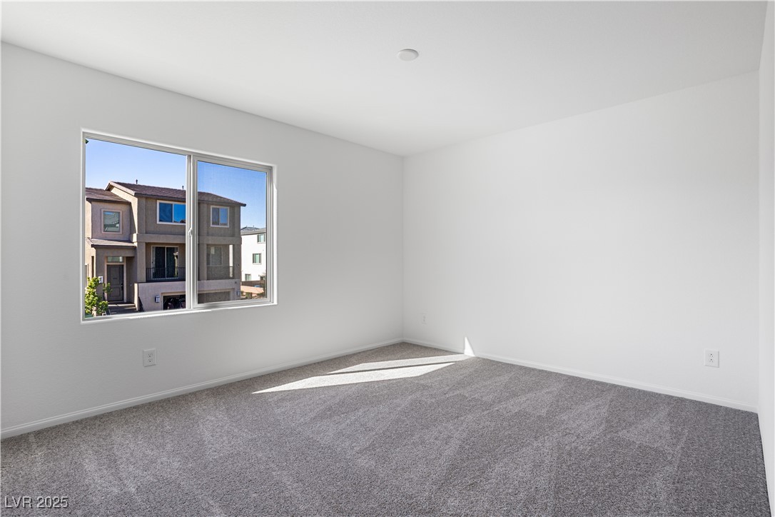 5670 Spring Trellis Street Las Vegas, NV 89113 - Photo 8 of 23 Unfurnished room with carpet floors and baseboards