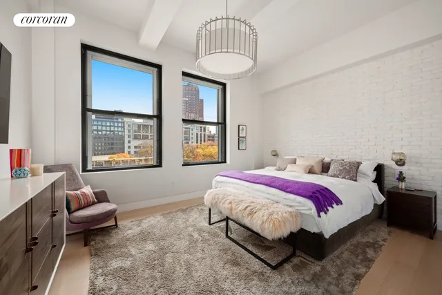 a living room with furniture flowers and a chandelier