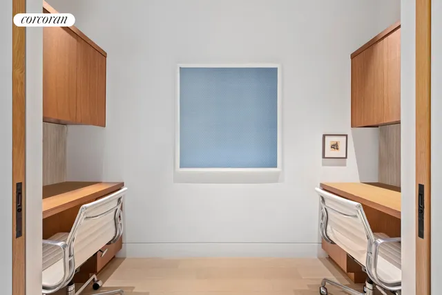 a room with a book shelf and a dresser