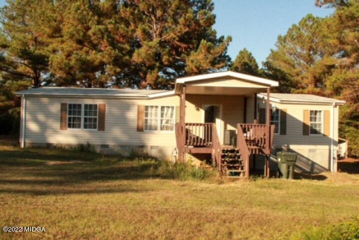 a view of a house with backyard porch and furniture