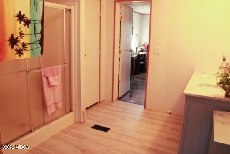 362 Chestnut Hill Road Fort Valley, GA 31030 - Photo 13 of 23 a view of a hallway with wooden floor and a bathroom