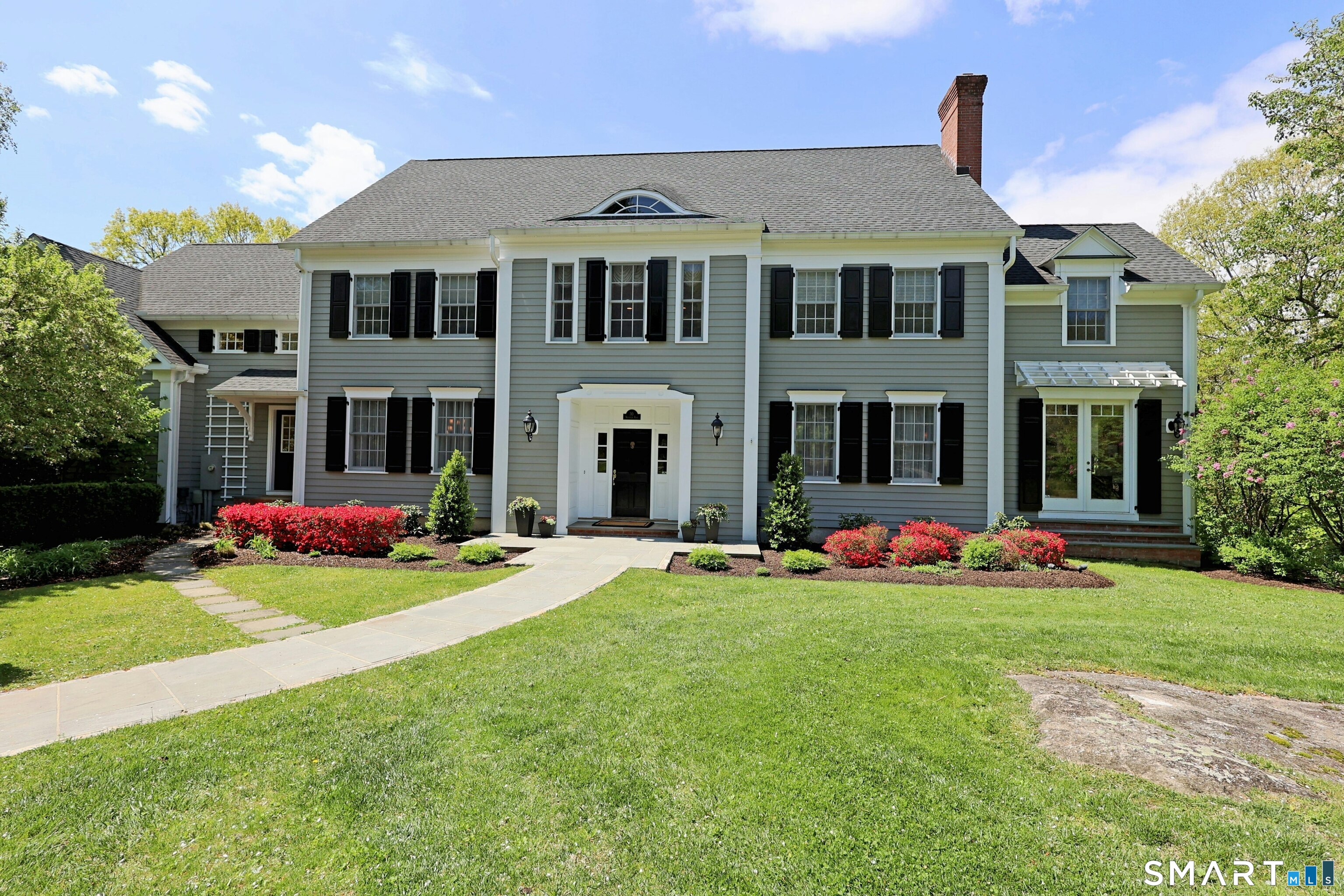 30 Whipstick Road Ridgefield, CT 06877 - Photo 10 of 40 a front view of a house with a yard and garage