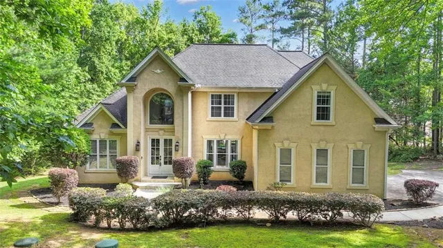 a front view of house with yard and green space