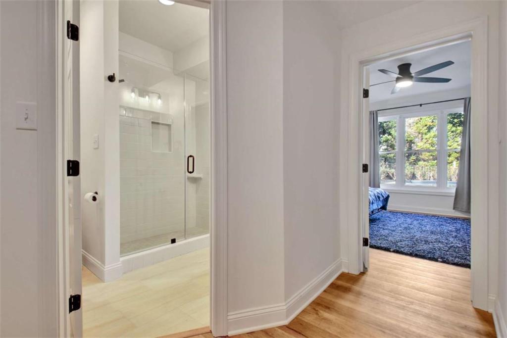 551 Lees Mill Road Fayetteville, GA 30214 - Photo 34 of 38 a view of a hallway with wooden floor and living room