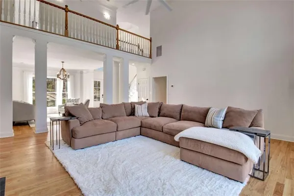 a living room with furniture a ceiling fan and a rug