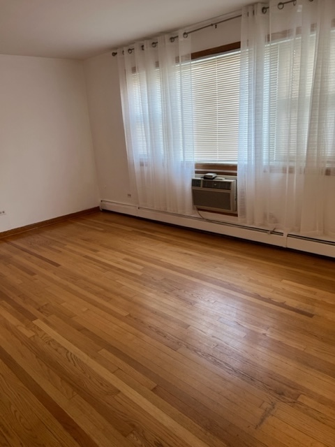 6850 Cermak Road, Unit 1B Berwyn, IL 60402 - Photo 3 of 15 a view of wooden floor and windows in a room