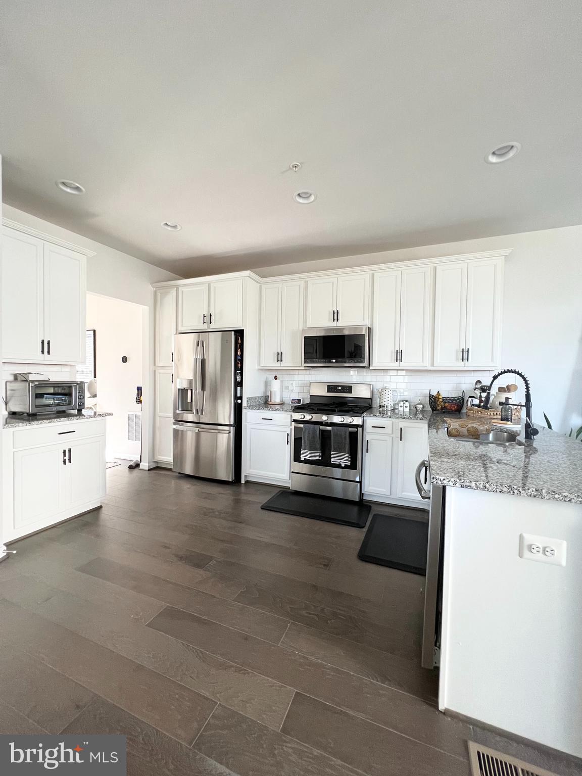 3501 Landing Way Silver Spring, MD 20906 - Photo 12 of 42 a kitchen with stainless steel appliances granite countertop a stove top oven a sink a refrigerator and white cabinets