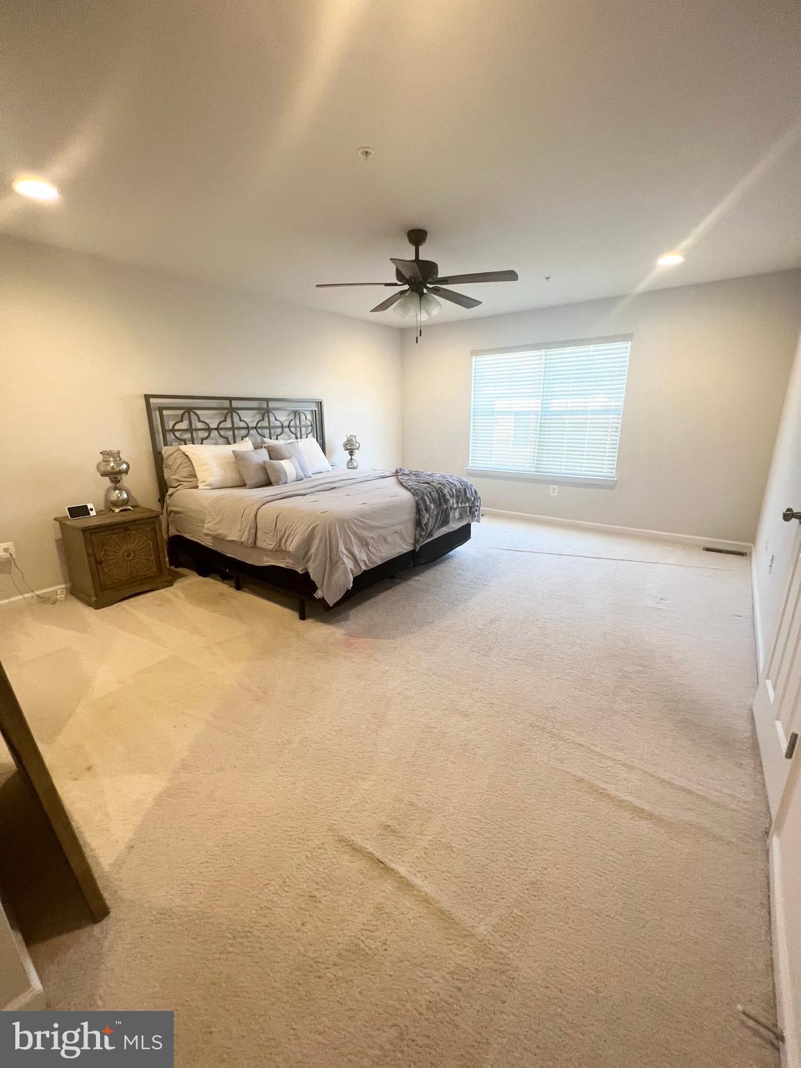 3501 Landing Way Silver Spring, MD 20906 - Photo 28 of 42 a spacious bedroom with a bed and a ceiling fan