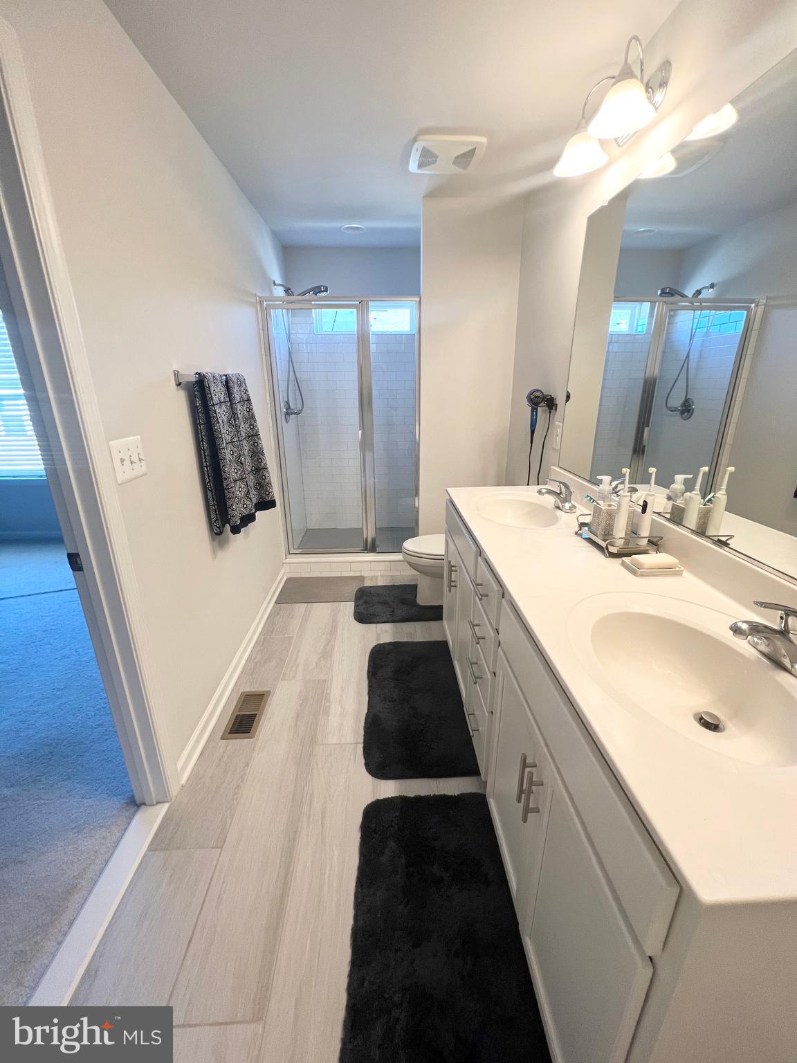 3501 Landing Way Silver Spring, MD 20906 - Photo 31 of 42 a spacious bathroom with a double vanity sink and a mirror