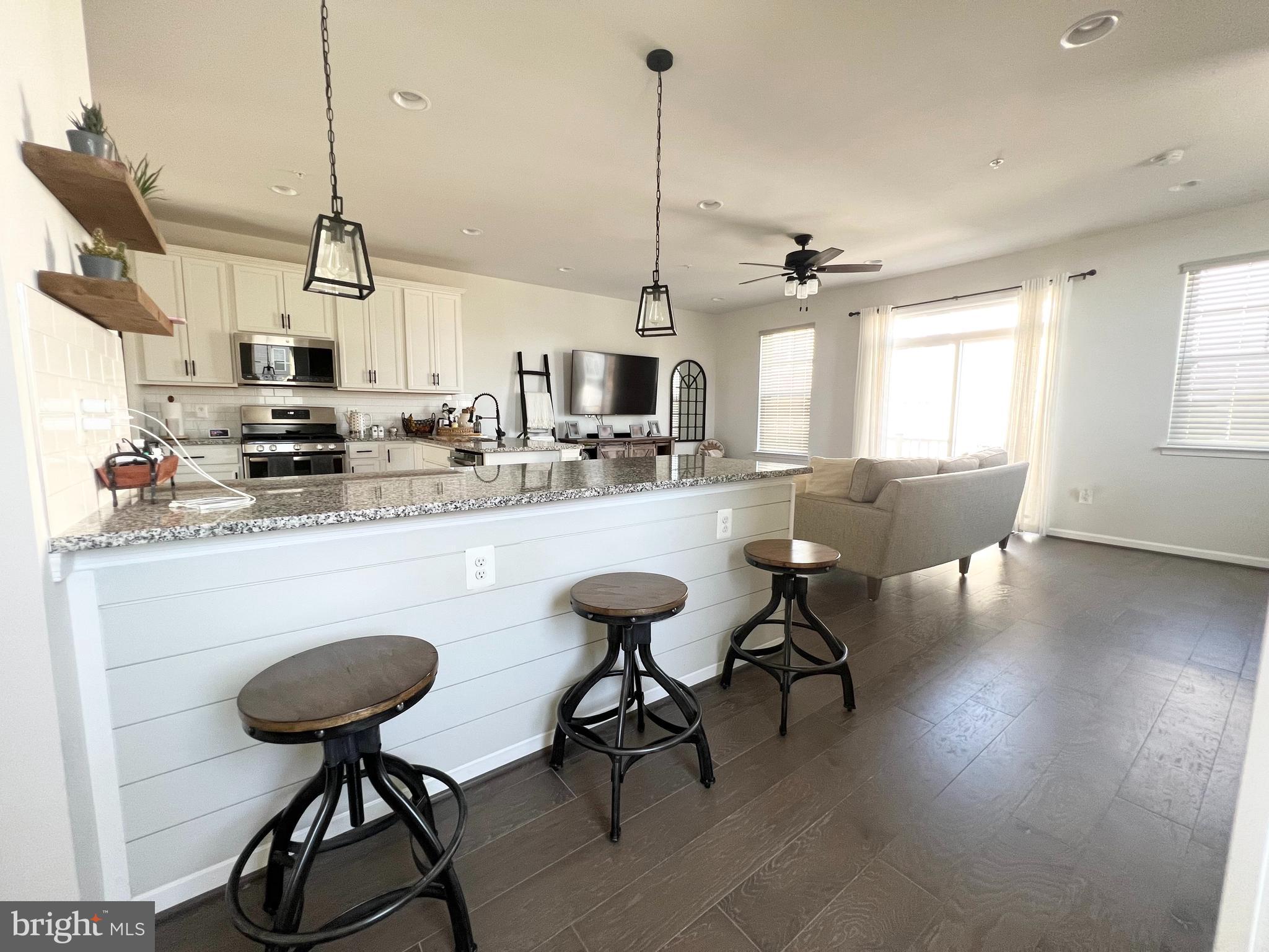 3501 Landing Way Silver Spring, MD 20906 - Photo 9 of 42 a kitchen with stainless steel appliances granite countertop a table chairs stove and cabinets