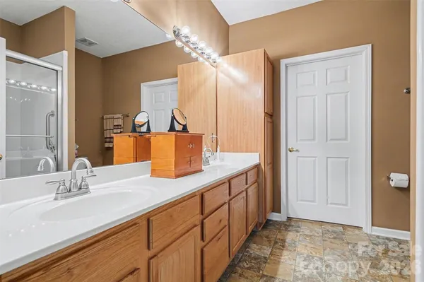 a bathroom with a double vanity sink and a mirror