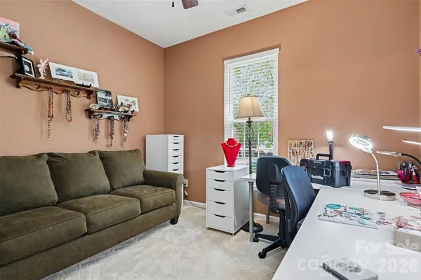 a view of a livingroom with workspace and a couch