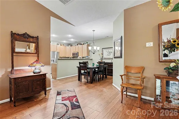a living room with furniture and kitchen view