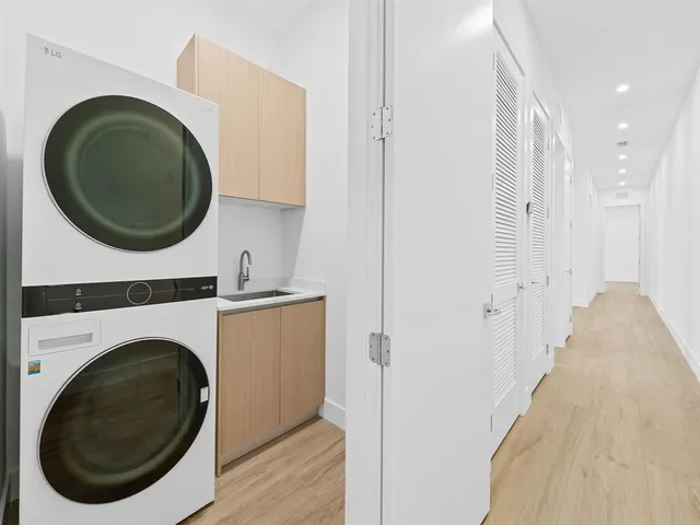 a view of a hallway with washer and dryer