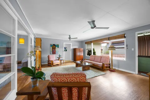 a living room with furniture and wooden floor