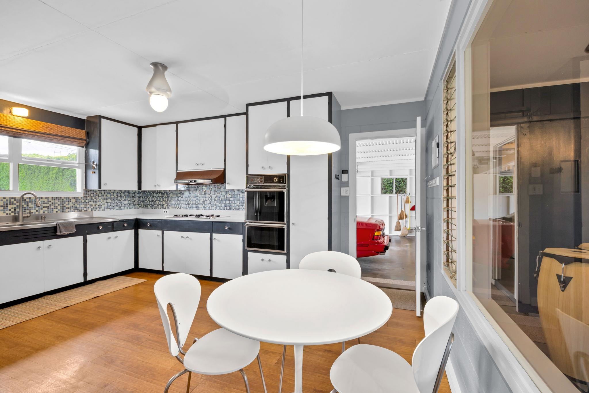 1199 Freitas Place Makawao, HI 96768 - Photo 22 of 49 a kitchen with stainless steel appliances kitchen island granite countertop a dining table chairs and a refrigerator