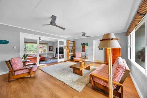 a living room with furniture and a wooden floor