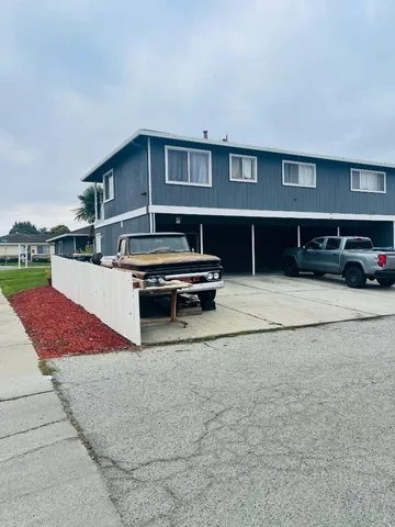 a swimming pool with outdoor seating and a yard