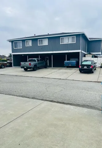 a front view of a house with a parking space