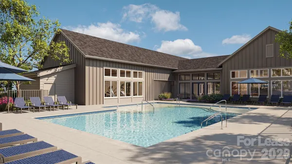 a view of a house with swimming pool and sitting area