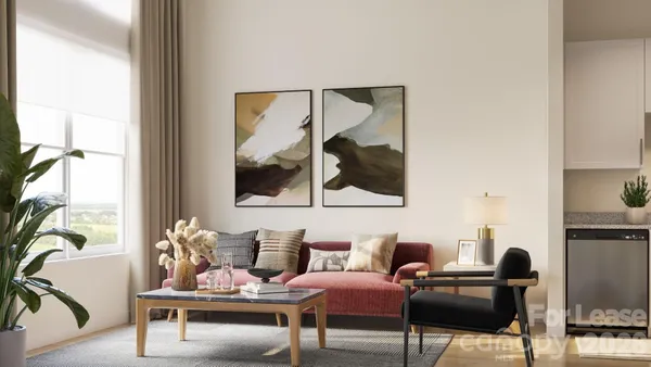 a living room with furniture and a painting on the wall