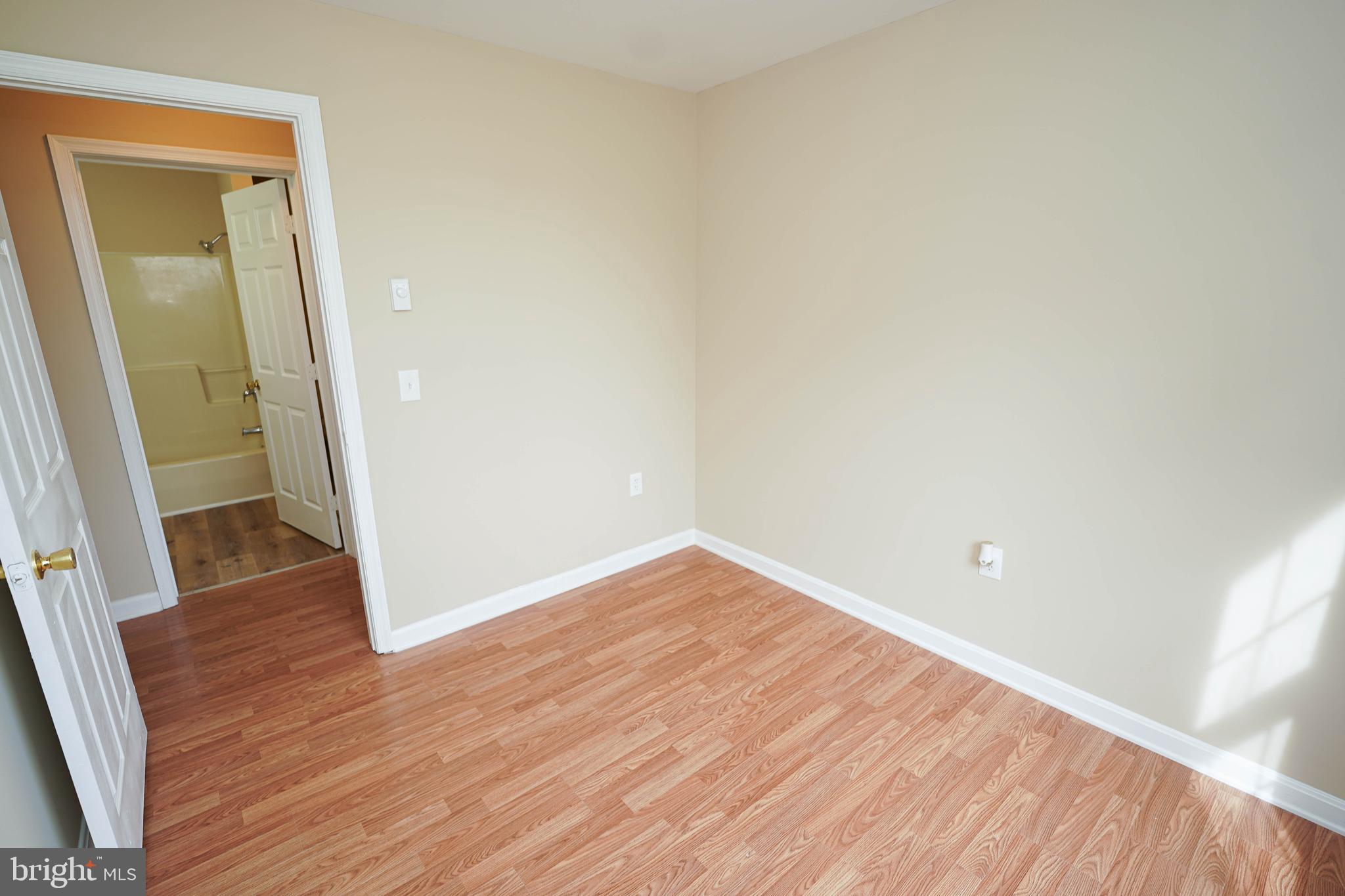 7526 Bethel Road Willards, MD 21874 - Photo 21 of 34 an empty room with wooden floor and entrance