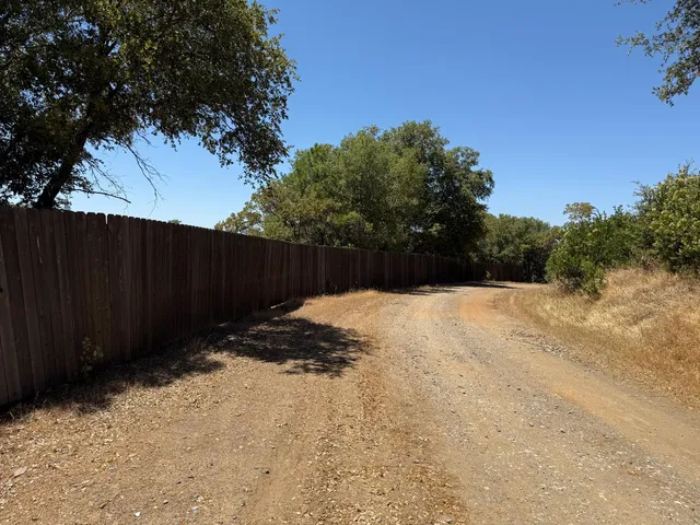 a backyard of a house with wooden fence