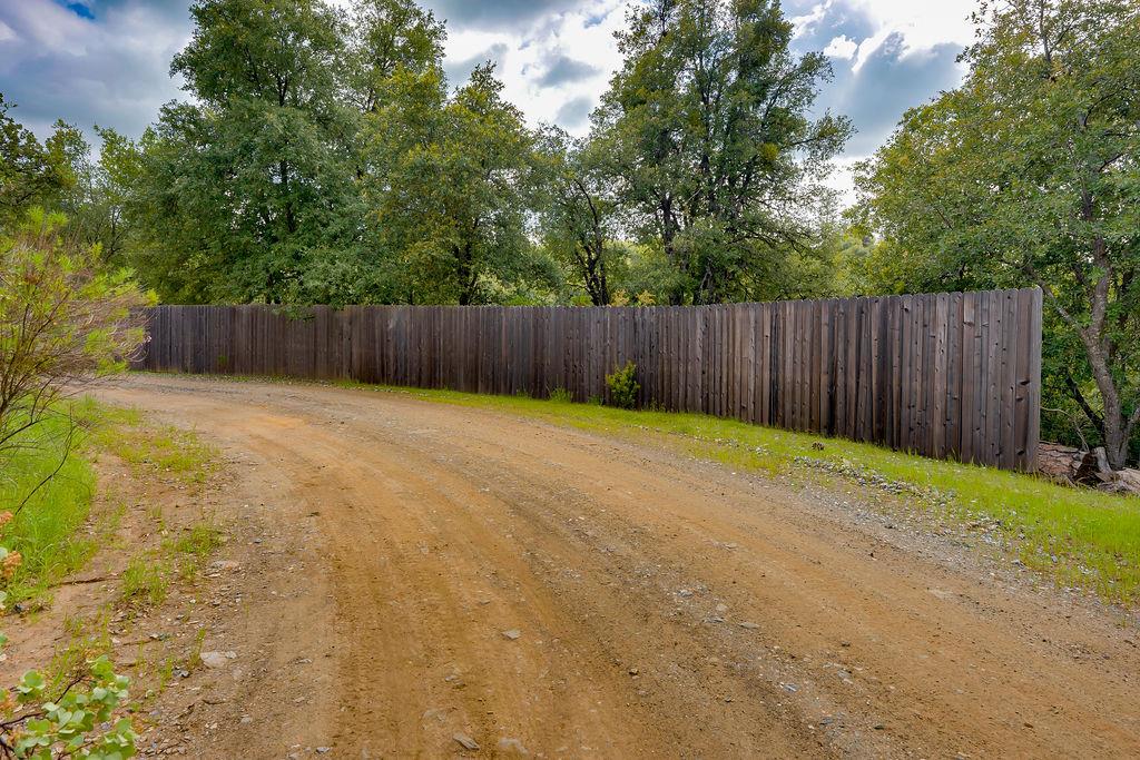 5068 Pappalardo Promenade Murphys, CA 95247 - Photo 3 of 15 a swimming pool with wooden fence