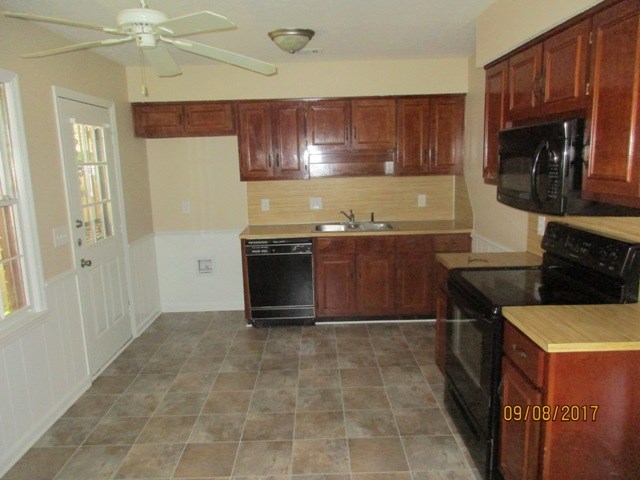 1742 Bunker Hill Road Columbus, GA 31907 - Photo 4 of 16 a kitchen with granite countertop a stove a sink and a microwave