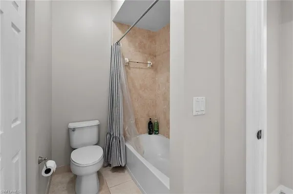 a bathroom with a toilet and a bathtub