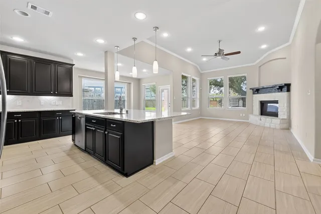 a large kitchen with a large counter top and stainless steel appliances