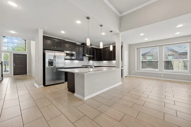 a kitchen with stainless steel appliances kitchen island granite countertop a sink and cabinets