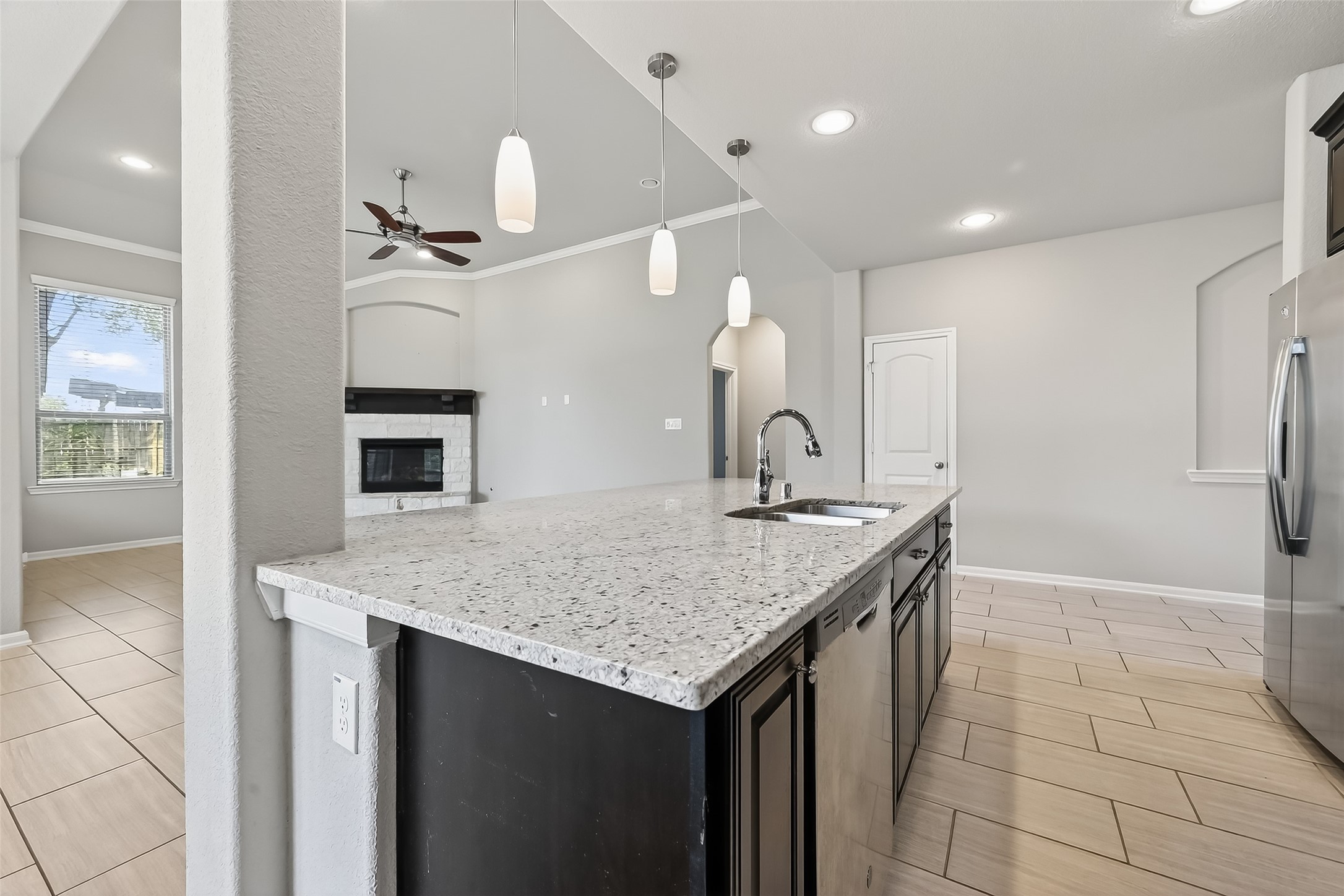 4718 Verbena Valley Way Spring, TX 77388 - Photo 7 of 24 a kitchen with a sink a counter space and a refrigerator