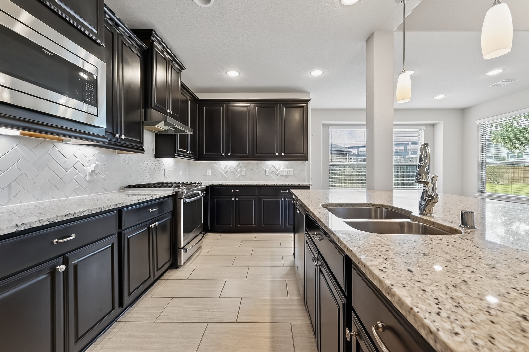4718 Verbena Valley Way Spring, TX 77388 - Photo 8 of 24 a kitchen with stainless steel appliances granite countertop a sink and stove
