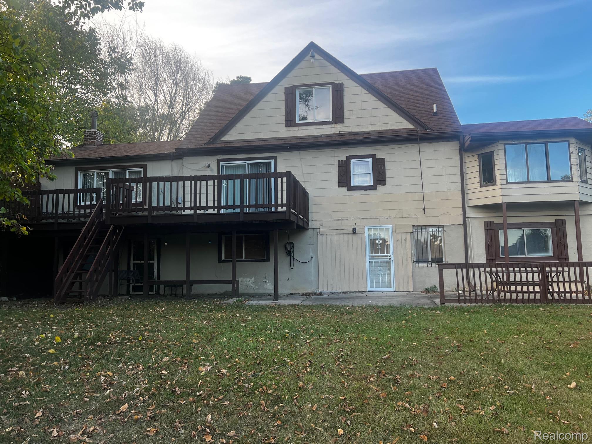 3364 East Pierson Road Flint, MI 48506 - Photo 63 of 67 Rear view of property with a deck, a yard, a patio area, and stairway