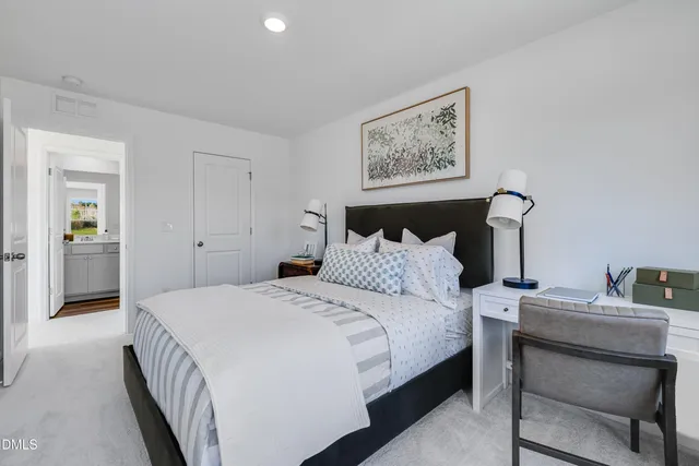 a bedroom with a bed and a table