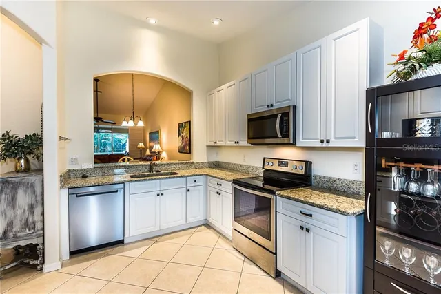 a kitchen with granite countertop stainless steel appliances and sink