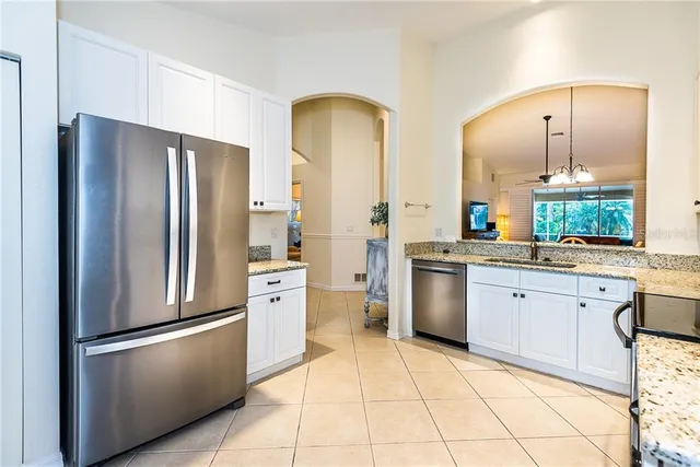 a kitchen with stainless steel appliances a refrigerator sink and cabinets