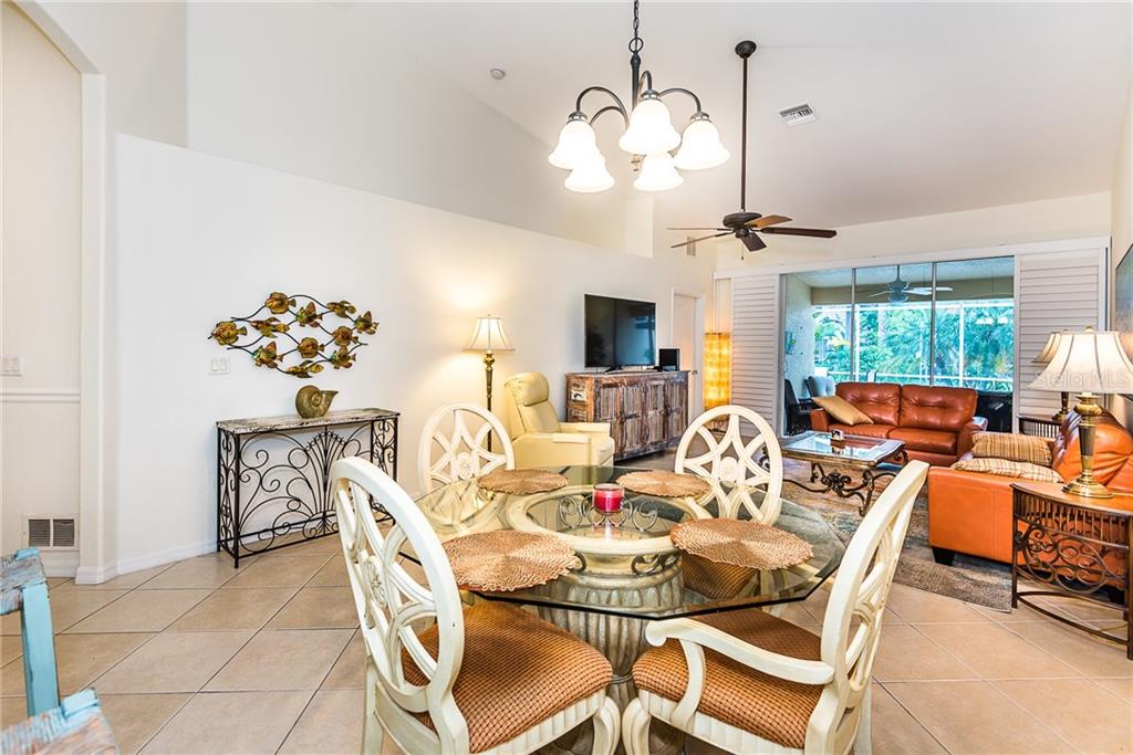 3800 Tripoli Boulevard, Unit 35 Punta Gorda, FL 33950 - Photo 19 of 44 a view of a dining room with furniture a chandelier and large windows