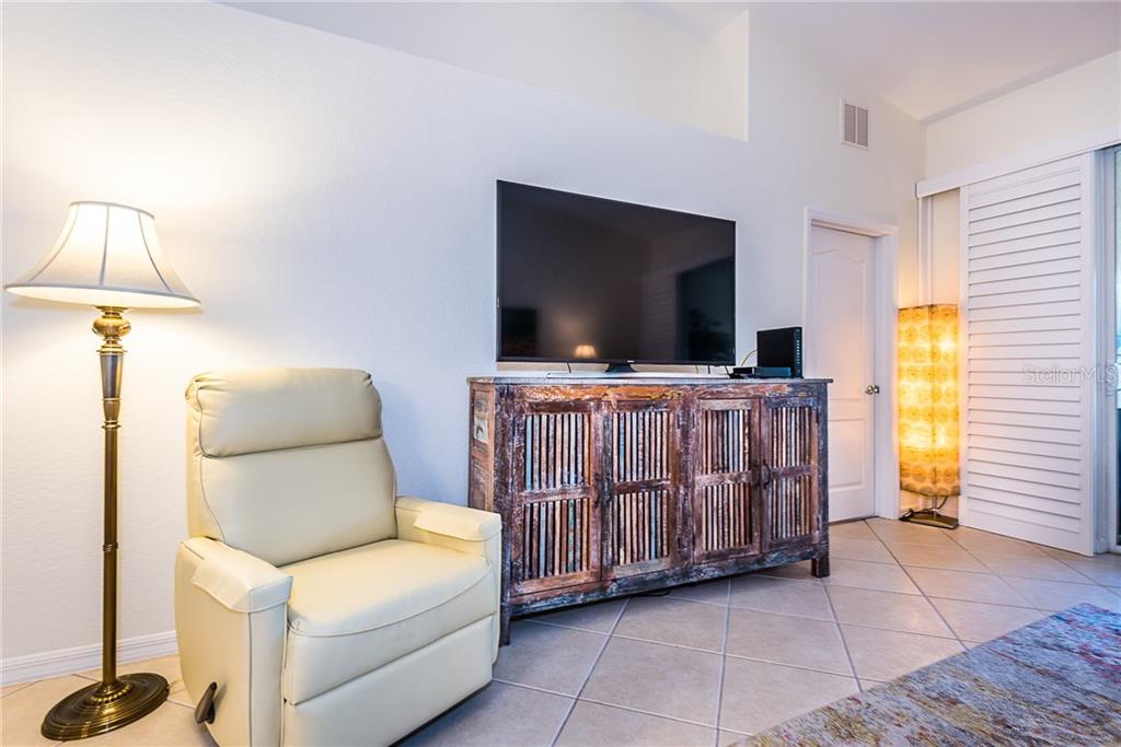 3800 Tripoli Boulevard, Unit 35 Punta Gorda, FL 33950 - Photo 23 of 44 a living room with furniture and a flat screen tv