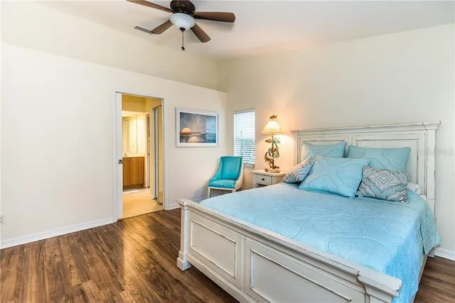 a bedroom with a bed and flat screen tv