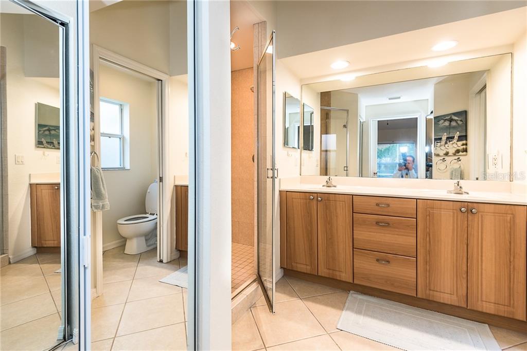 3800 Tripoli Boulevard, Unit 35 Punta Gorda, FL 33950 - Photo 30 of 44 a bathroom with a granite countertop sink toilet and shower