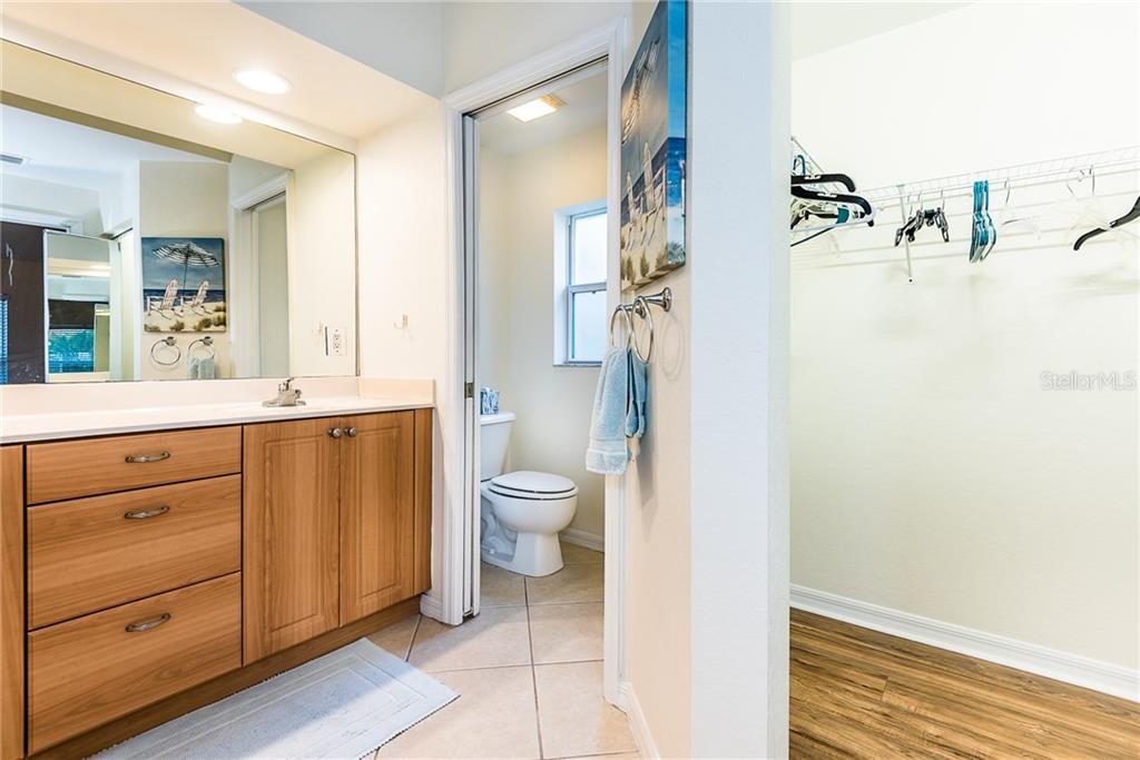 3800 Tripoli Boulevard, Unit 35 Punta Gorda, FL 33950 - Photo 32 of 44 a bathroom with a granite countertop sink toilet and shower