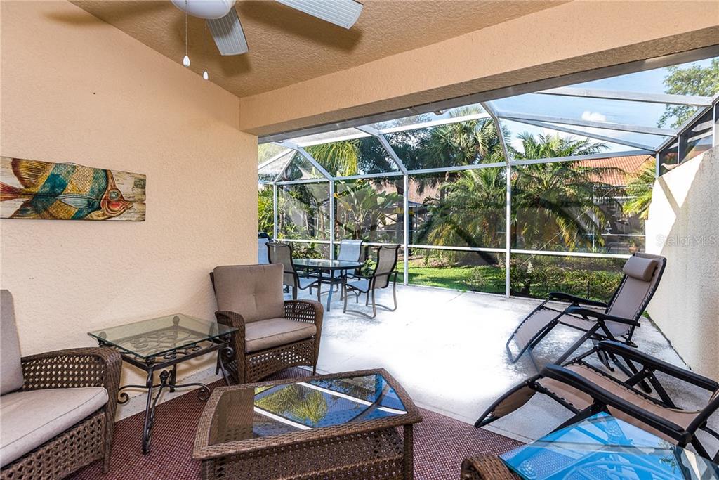 3800 Tripoli Boulevard, Unit 35 Punta Gorda, FL 33950 - Photo 35 of 44 a living room with furniture and a floor to ceiling window